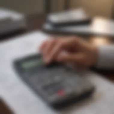 A person analyzing financial documents with a calculator and notepad