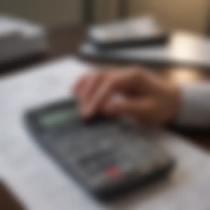 A person analyzing financial documents with a calculator and notepad